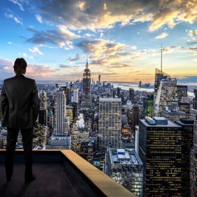 Businessman watching the New York City on the rooftop of skyscraper